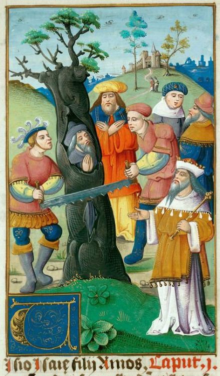 The prophet Isaiah, hiding in a tree is sawn in two at the orders of King Manasseh.