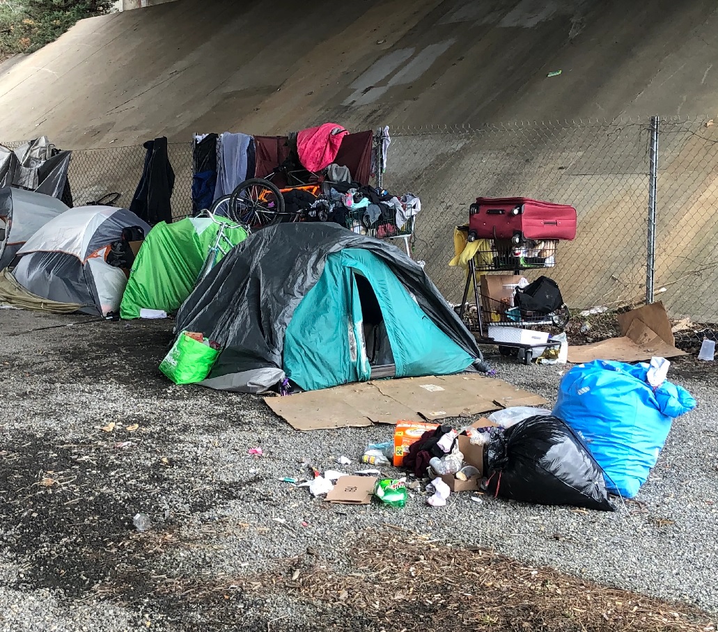 A picture containing ground, tent, clothes, dirty

Description automatically generated